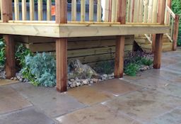 Patio, Raised Decking and pebble border with feature planting