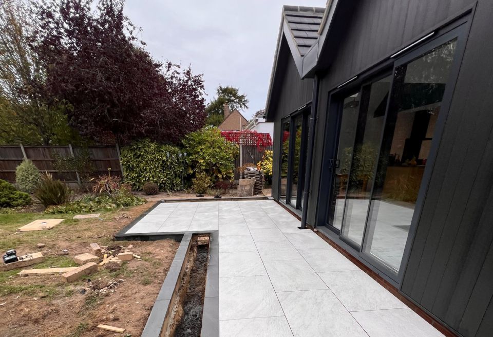 Contemporary black and white porcelain patio Norwich  - Integrated Planting Beds