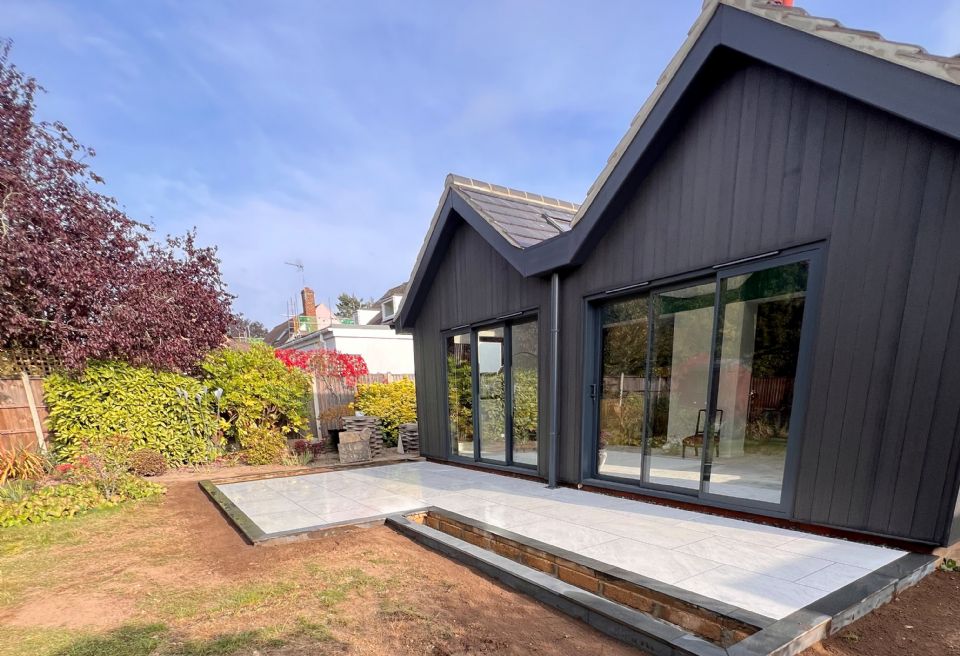 Contemporary black and white porcelain patio Norwich  - Porcelain colour scheme matches the new build extension